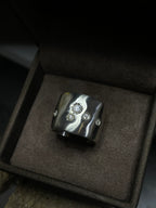 Silver ring with moissanite in a brown box
