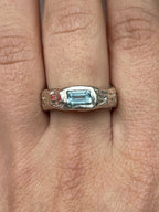 Silver handmade ring with a blue sky topaz on a finger