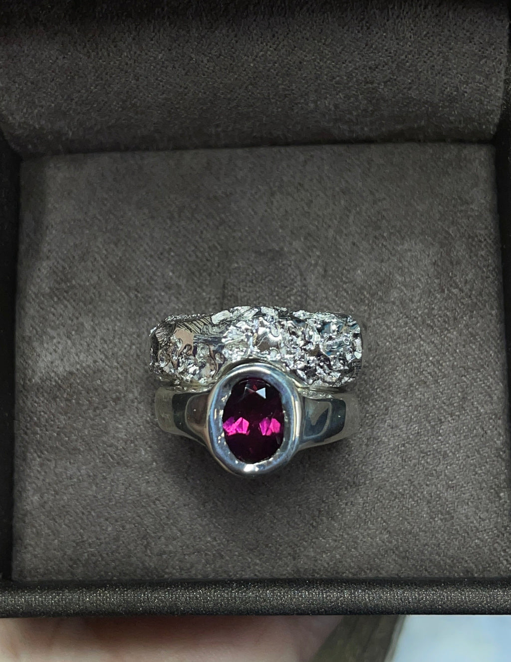 Two rings with rhodolite garnet in a box.