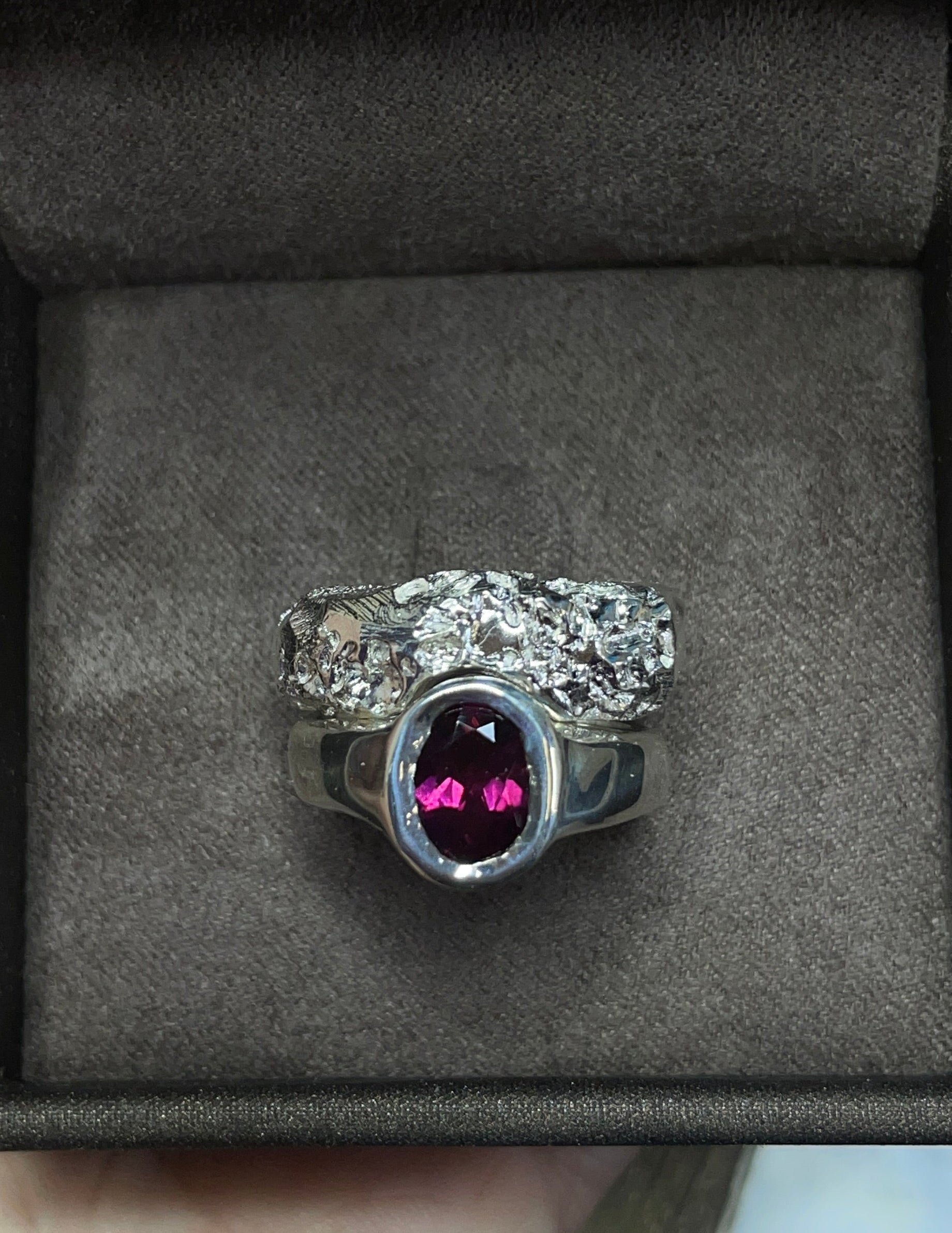 Two rings with rhodolite garnet in a box.