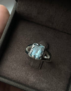 Ring with a  sky topaz in a box